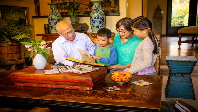A family remembers their loved one as they peruse family photo albums preparing for a Celebration of Life. 
