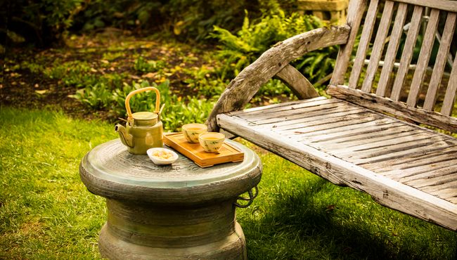 Traditional tea service and welcoming bench offer a quiet place for reflection. 
