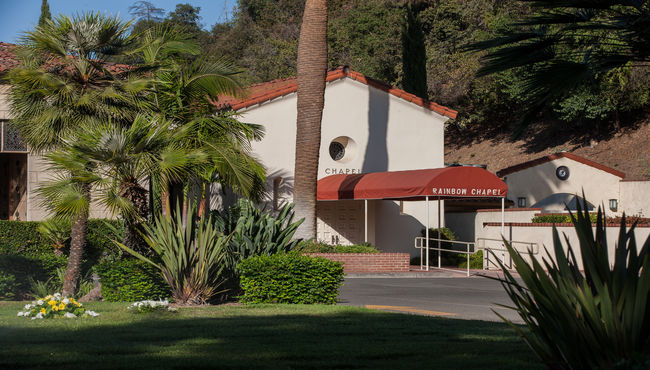 Tropical plants flank the entrance to Rose Hills' first dedicated chapel, Rainbow Chapel. 